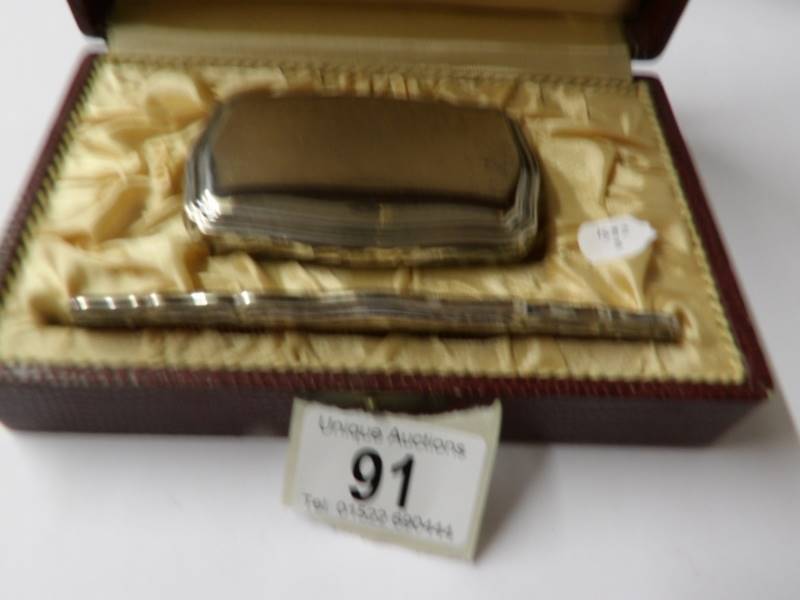 A cased silver backed hair brush and comb.