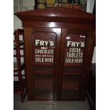 A 2 door display cabinet with Frys Chocolate advertising to doors