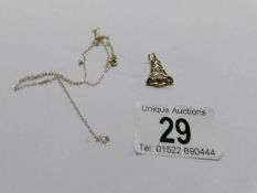 A 9ct gold bell pendant and a finr 9ct gold chain (chain a/f), 1.4 grams.