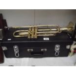 A cased brass trumpet, not named.
