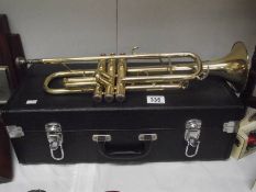 A cased brass trumpet, not named.