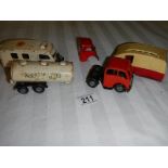 A Triang Minic tinplate clockwork ambulance, a milk tanker and a caravan.