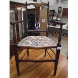 An Edwardian inlaid elbow chair.