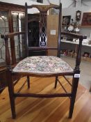 An Edwardian inlaid elbow chair.