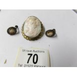 A 19th century carved cameo brooch and later silver cameo earrings.