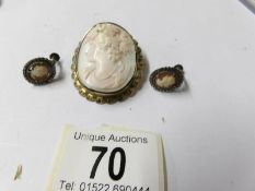 A 19th century carved cameo brooch and later silver cameo earrings.