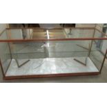 A glass shop cabinet. 61" long x 19.