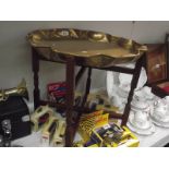 An Eastern brass tray table with folding base.