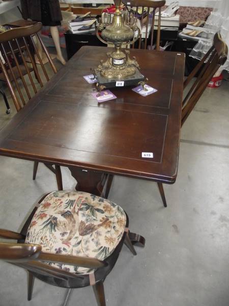 A dark oak draw leaf table and 4 Ercol chairs.