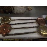 4 Victorian copper and brass bed warming pans.