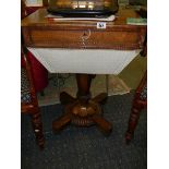 A Victorian figured rosewood sewing table.