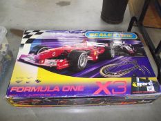 A Scalextric Formula 1 X 3 racing set.