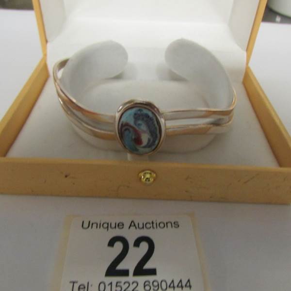 An Irish silver plate and enamel bracelet.