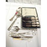 A cased set of butter knives, salad servers, serving spoons, grape scissors etc.