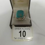 A silver ring set turquoise, size O.