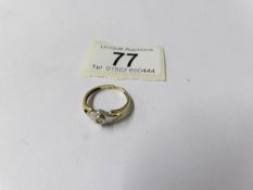 A hand made two tone gold diamond solitaire ring, size N.