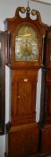 An oak long case clock, 8 day, arched dial with sun motif.