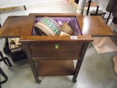 A 1930's oak sewing box with contents.