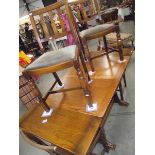 A 1950's oak draw leaf table with 4 chairs.