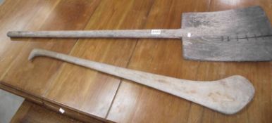 An old wooden shovel and another wooden implement.