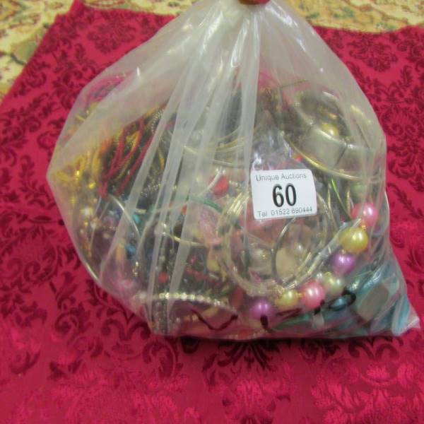 A bag of mixed costume jewellery, approximately 3.5 kg.