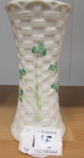 A Belleek vase decorated with shamrocks, 14 cm tall.