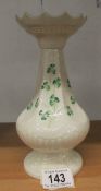 A Belleek vase decorated with shamrocks, 20 cm tall.