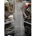 A fairytale wedding dress with heavy frilled net on a satin underskirt with a train,