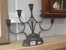 A white metal 5 arm candelabra.