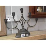 A white metal 5 arm candelabra.