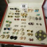 A case containing approximately 34 pairs of earrings including turquoise and pearl.