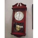 A constant red wood stained quartz wall clock