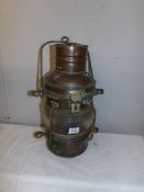 A large brass ships lamp, a/f (missing burner and glass cracked).