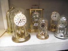 6 clocks including anniversary clocks under plastic domes