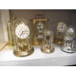 6 clocks including anniversary clocks under plastic domes