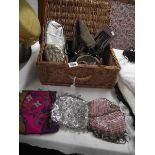 A wicker basket containing vintage evening bags etc.