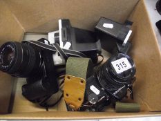 A Polaroid 1000 land camera, Polartronic 1, a Canon Eos 1000F camera with Sigma lens,