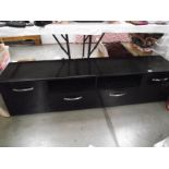 A long low black sideboard with drawers and cupboards.