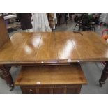 A Victorian mahogany wind out table with 2 leaves.