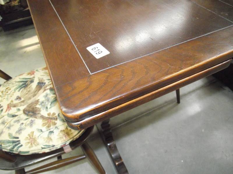 A dark oak draw leaf table and 4 Ercol chairs. - Image 4 of 4