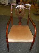 An Edwardian inlaid elbow chair.