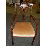 An Edwardian inlaid elbow chair.