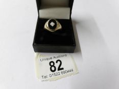 A 9ct yellow gold black onyx surrounded by 20pt diamonds ring, size R.