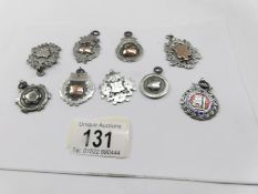 9 silver watch fobs.