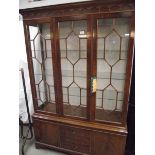 A good inlaid astragal glazed display cabinet with drawers and cupboards by Maples.