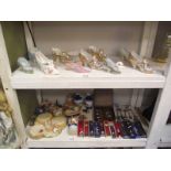 2 shelves of collectors shoes, spoons, 2 items of Pendelfin etc.