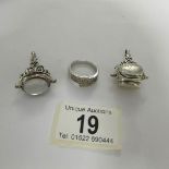 A silver ring and 2 silver fobs.