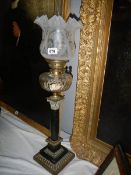 A black marble Corinthian column oil lamp with cut glass font.