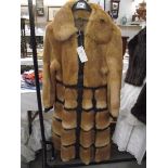 A 1970's leather/fur unusual design coat, rich golden fur set into dark leather,