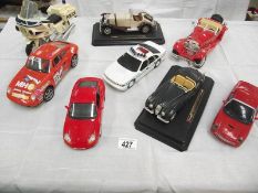 8 large scale die cast and plastic cars including Burago, Maistro etc.